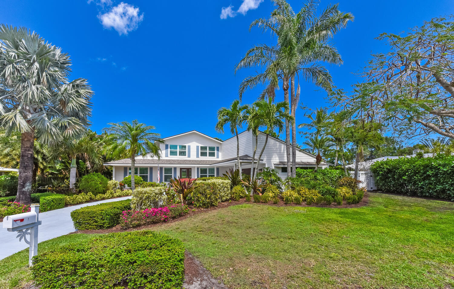 a front view of a house with a garden