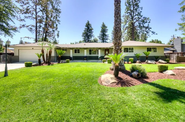 a front view of a house with a yard table and chairs