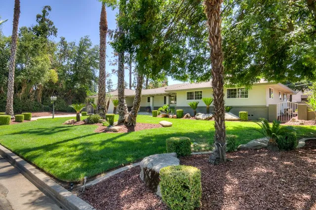 a view of a house with backyard sitting area and garden