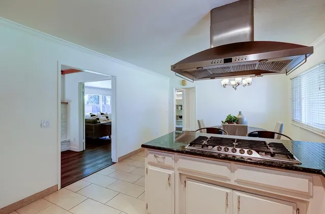 a kitchen with granite countertop a stove and a refrigerator