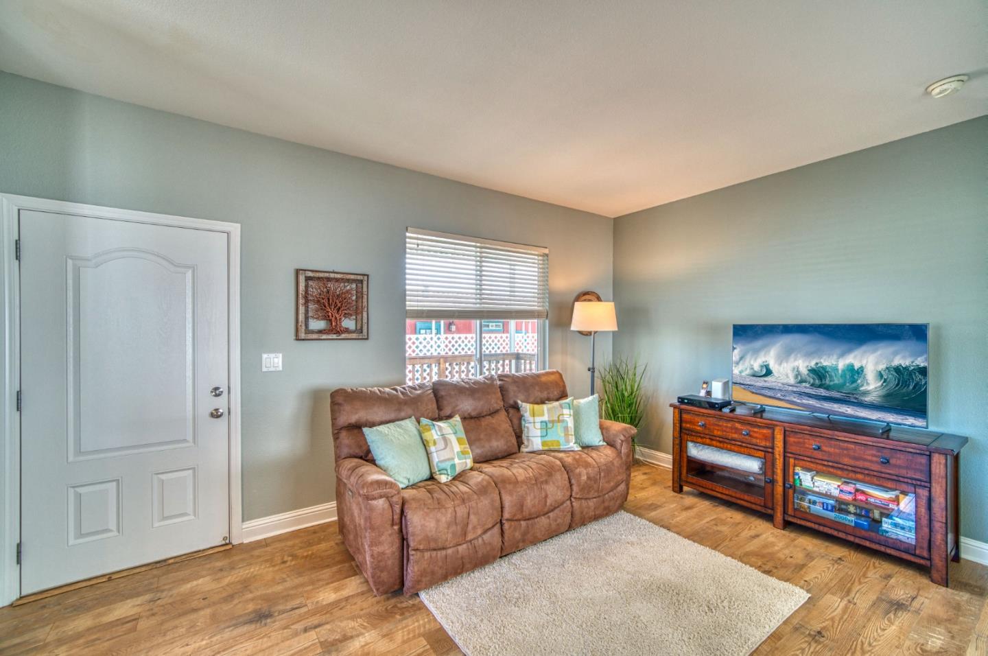 7 Lighthouse Road, Unit 7 Half Moon Bay, CA 94019 - Photo 15 of 22 a living room with furniture and a flat screen tv