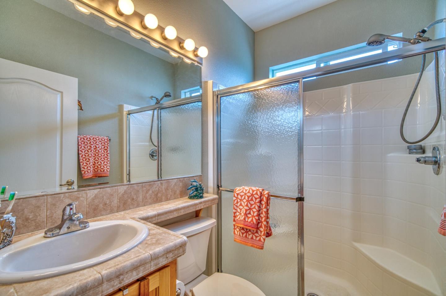 7 Lighthouse Road, Unit 7 Half Moon Bay, CA 94019 - Photo 19 of 22 a bathroom with a sink mirror vanity and toilet