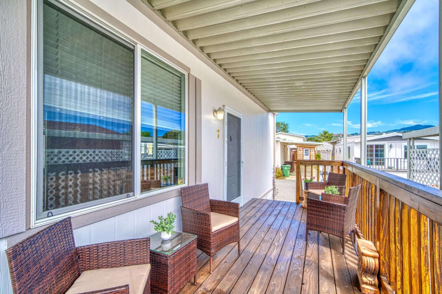 7 Lighthouse Road, Unit 7 Half Moon Bay, CA 94019 - Photo 5 of 22 a balcony with wooden floor and outdoor seating