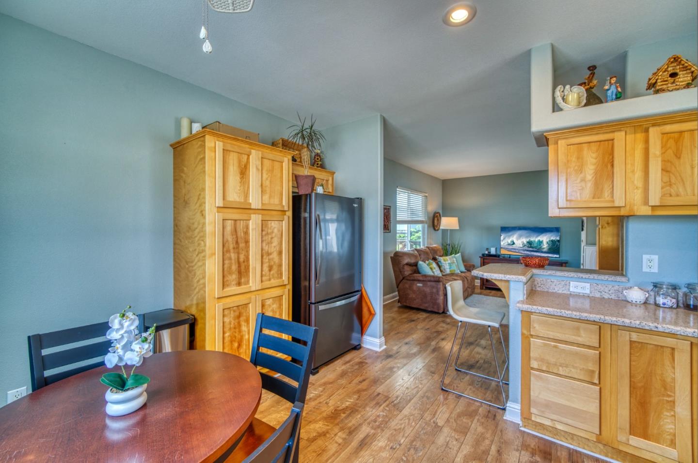 7 Lighthouse Road, Unit 7 Half Moon Bay, CA 94019 - Photo 8 of 22 a kitchen with stainless steel appliances granite countertop wooden cabinets a dining table and chairs