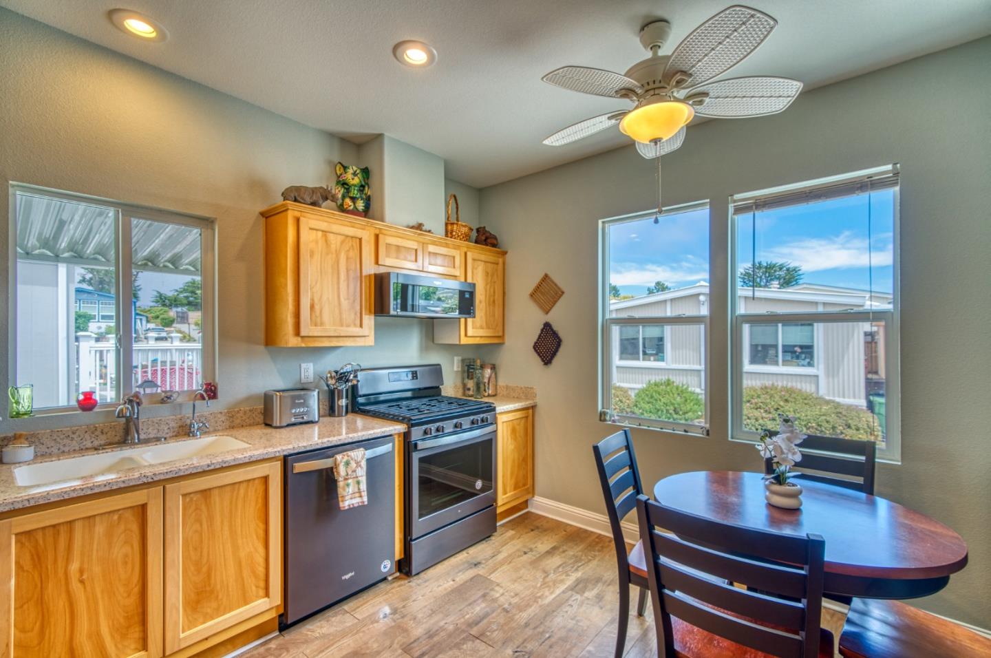 7 Lighthouse Road, Unit 7 Half Moon Bay, CA 94019 - Photo 9 of 22 a kitchen with a stove a sink a dining table and chairs