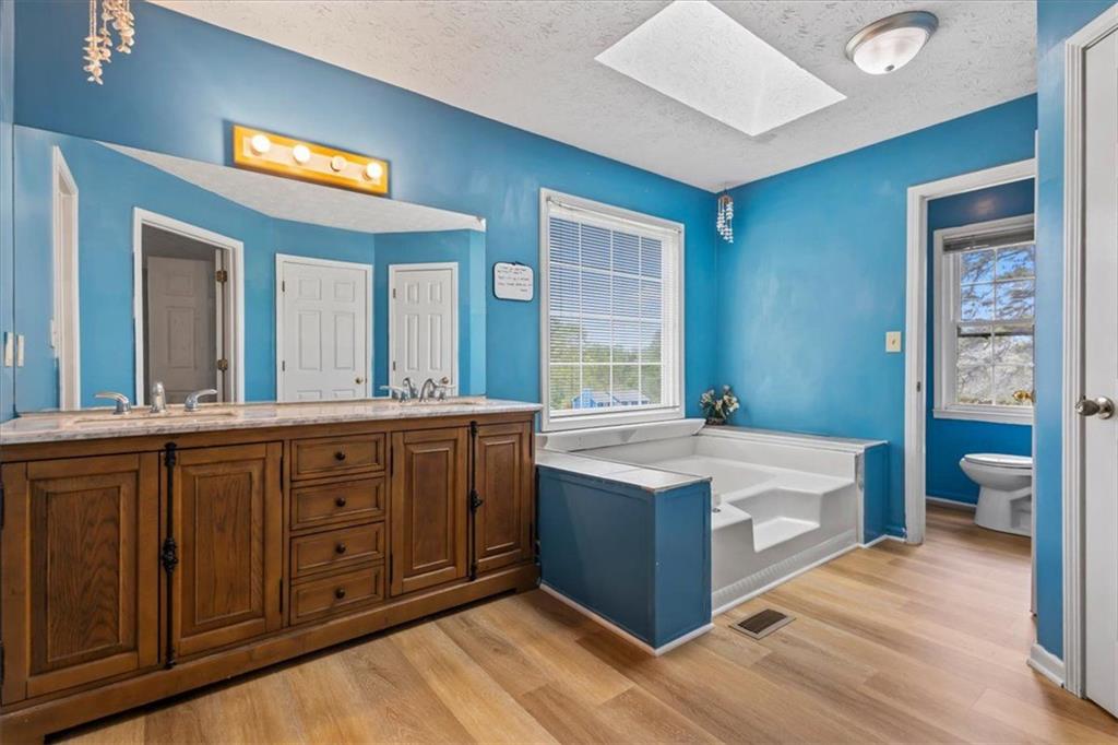 30 Paces Meadows Lane Dallas, GA 30157 - Photo 19 of 40 a spacious bathroom with a tub double vanity and a large mirror