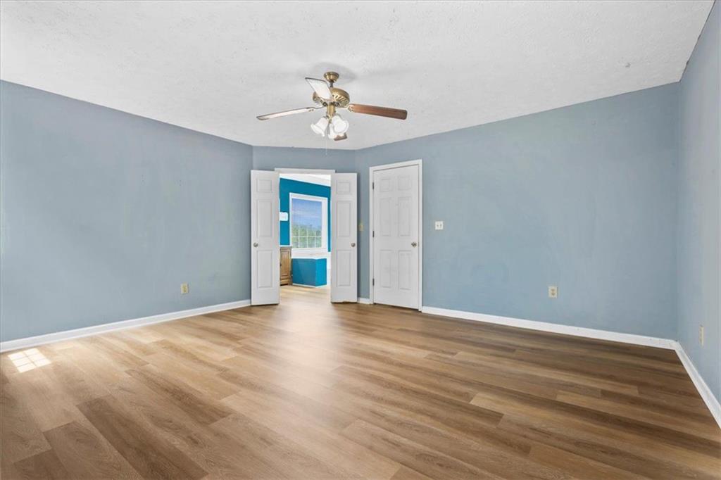 30 Paces Meadows Lane Dallas, GA 30157 - Photo 23 of 40 a view of an empty room with chandelier fan and wooden floor