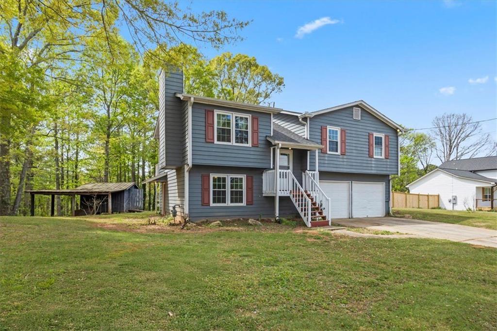 30 Paces Meadows Lane Dallas, GA 30157 - Photo 3 of 40 a front view of a house with garden