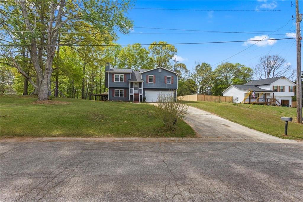 30 Paces Meadows Lane Dallas, GA 30157 - Photo 4 of 40 a view of a house with a big yard and large trees