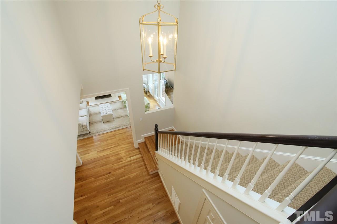 3112 Agecroft Road Raleigh, NC 27608 - Photo 14 of 29 a view of a hallway with wooden floor and staircase