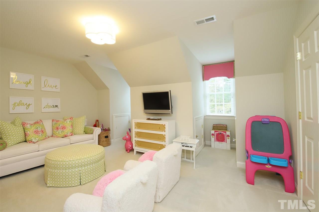 3112 Agecroft Road Raleigh, NC 27608 - Photo 22 of 29 a living room with furniture and a flat screen tv