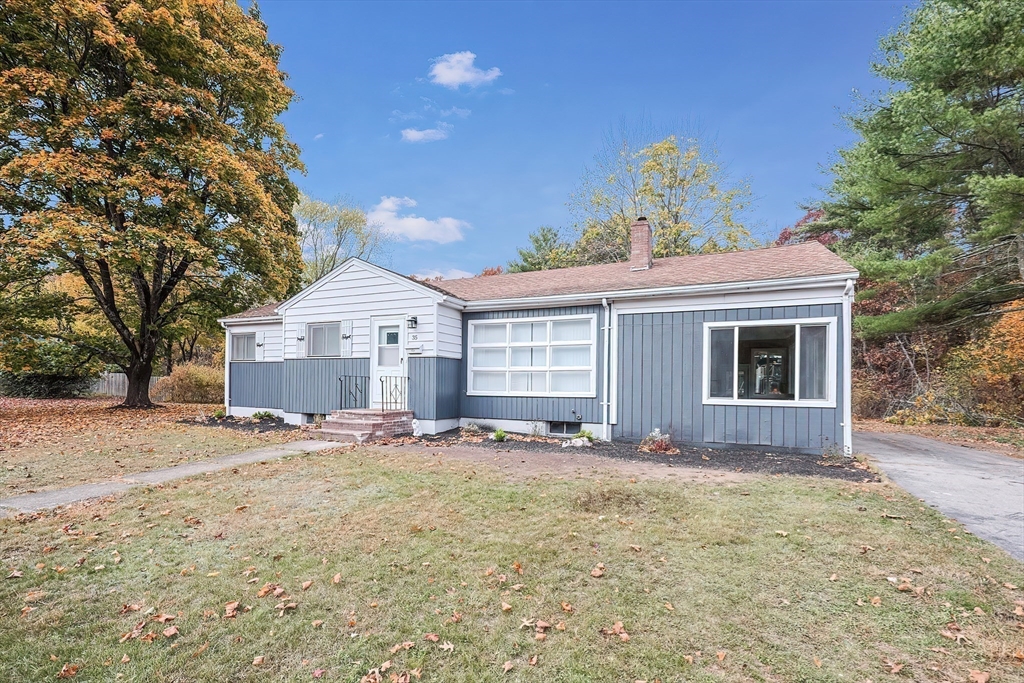 35 Deerfield Road Sharon, MA 02067 - Photo 31 of 31 a front view of a house with a yard and garage
