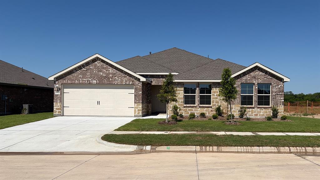 1923 Reveille Way Terrell, TX 75160 - Photo 1 of 33 Single-story residence featuring a brick and stone facade, a two-car garage, and a concrete driveway