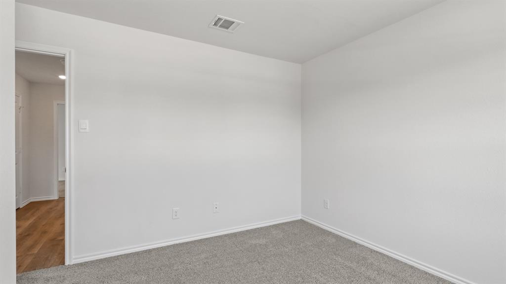 1923 Reveille Way Terrell, TX 75160 - Photo 27 of 33 Room featuring light gray carpet, white walls, and white baseboards