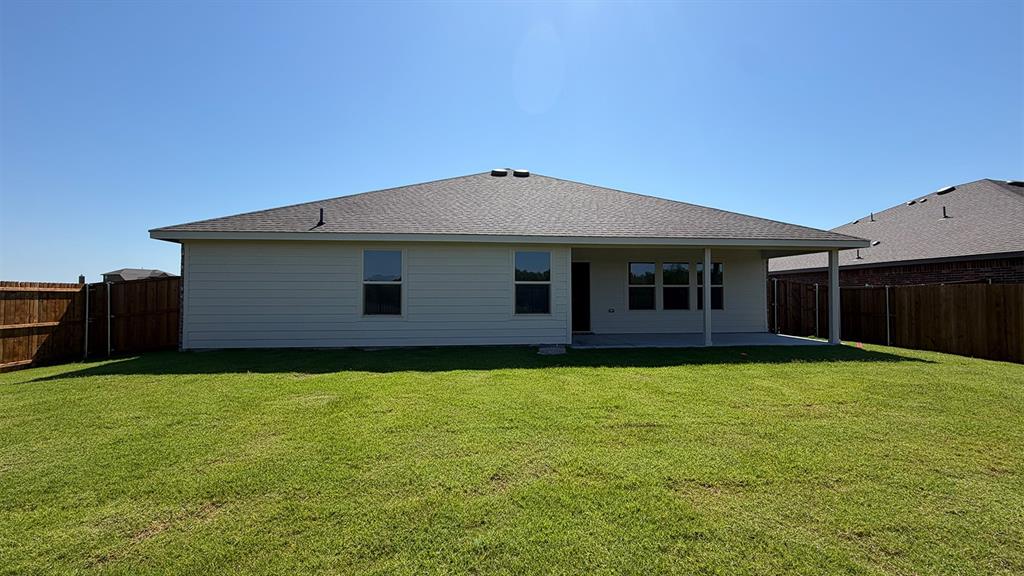 1923 Reveille Way Terrell, TX 75160 - Photo 30 of 33 Expansive green lawn with a full wooden fence