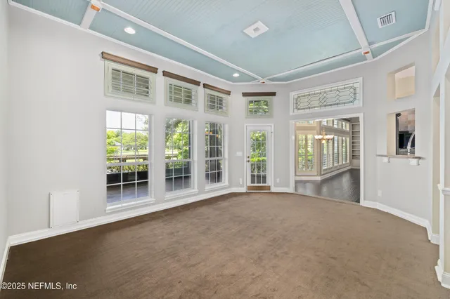 an aerial view of a house with a garden and lake view