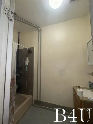 a bathroom with a tub and a sink