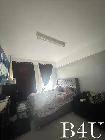 a bedroom with bed and window