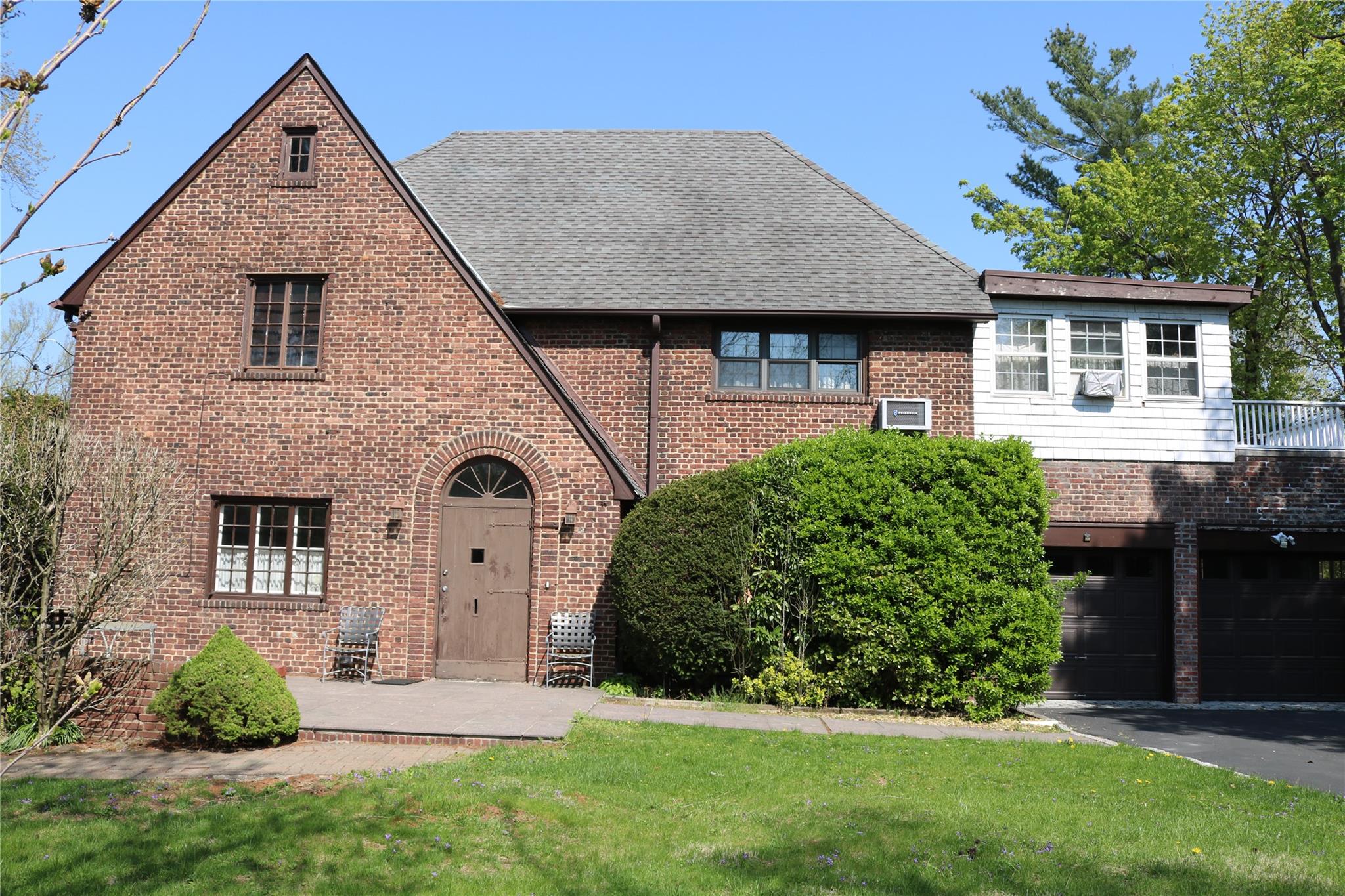 a front view of a house with a garden