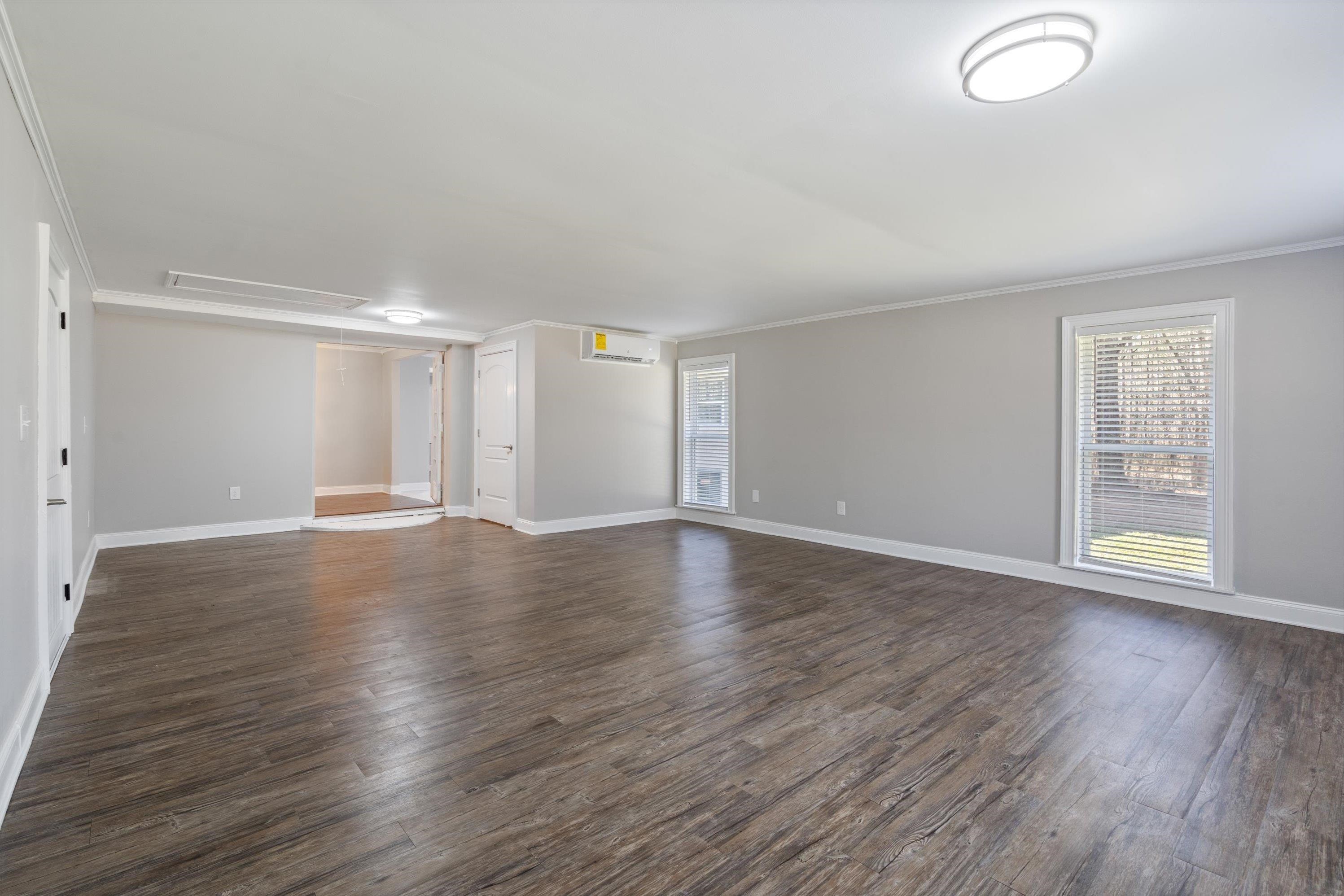 10464 East Holmes Road Collierville, TN 38017 - Photo 10 of 12 Empty room with dark wood-type flooring, attic access, plenty of natural light, and crown molding