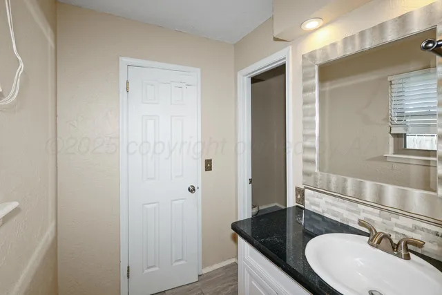 a bathroom with a sink and a mirror