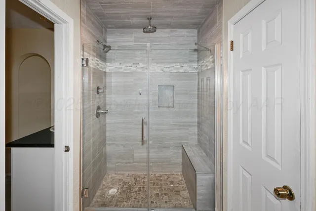 a view of a big room with wooden floor and windows