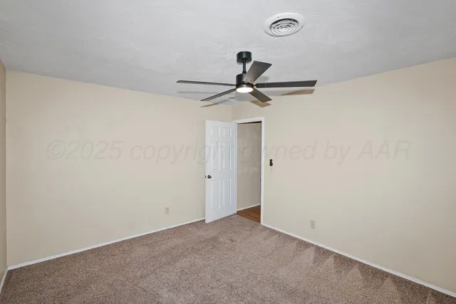a view of a big room with wooden floor closet and ceiling fan