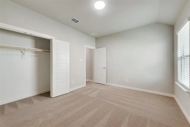 an empty room with windows and closet