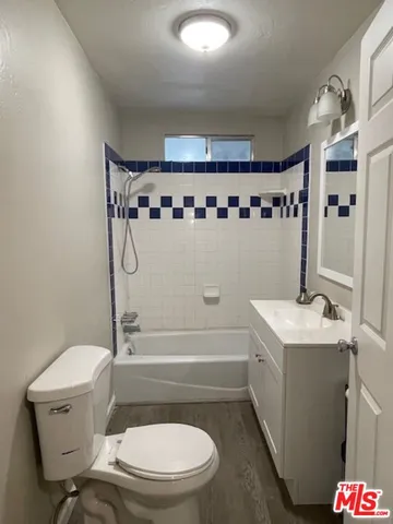 a bathroom with a toilet a sink and bathtub