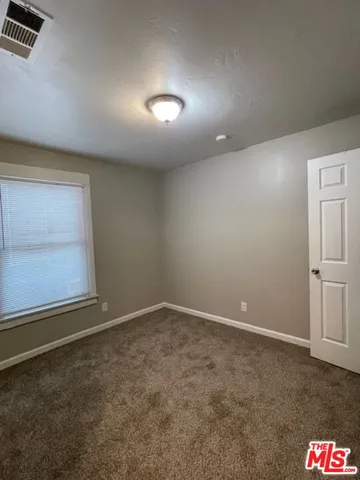 an empty room with a empty space and windows