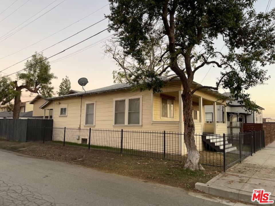 1608 E Street Bakersfield, CA 93301 - Photo 16 of 34 a white house that has a tree in front of it