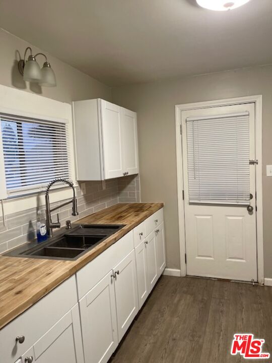 1608 E Street Bakersfield, CA 93301 - Photo 21 of 34 a kitchen with granite countertop white cabinets and sink
