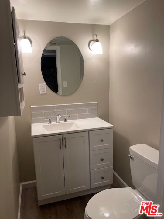 1608 E Street Bakersfield, CA 93301 - Photo 22 of 34 a bathroom with a toilet sink and mirror
