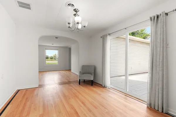 a view of a livingroom with furniture window and wooden floor