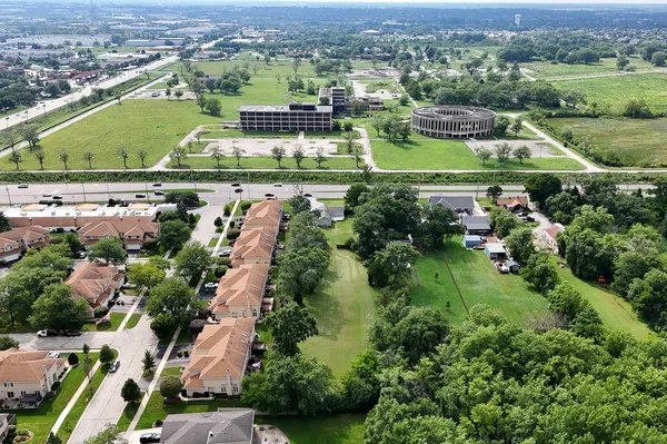 an aerial view of residential houses with outdoor space and river