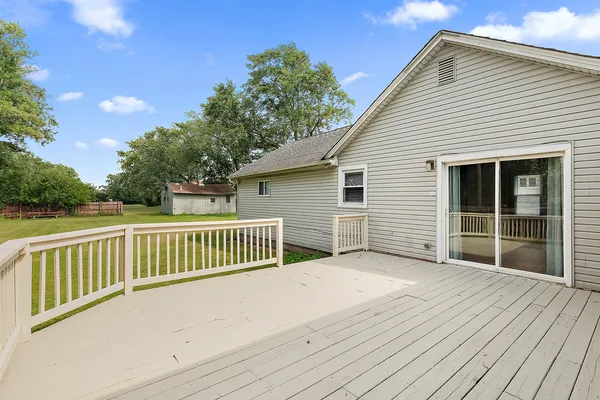 a view of a house with a wooden deck