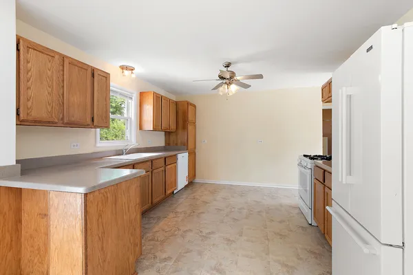 a kitchen with a refrigerator and a sink