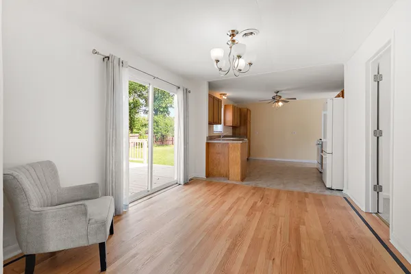 a view of a livingroom with a furniture wooden floor and a window