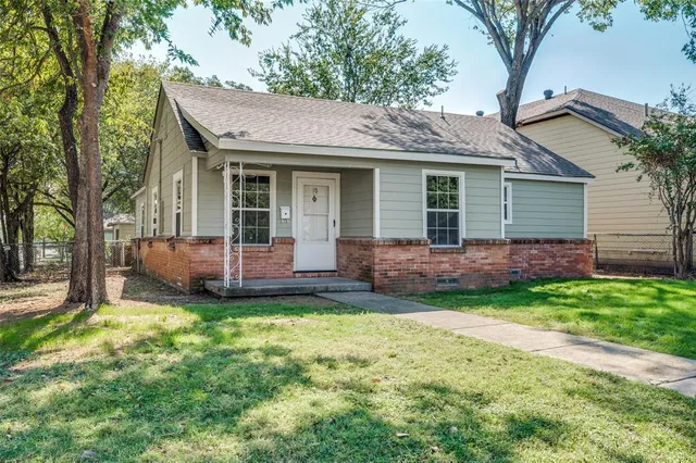 a view of a house with a yard and sitting area