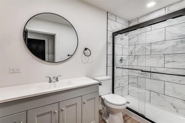 a bathroom with a sink toilet and shower