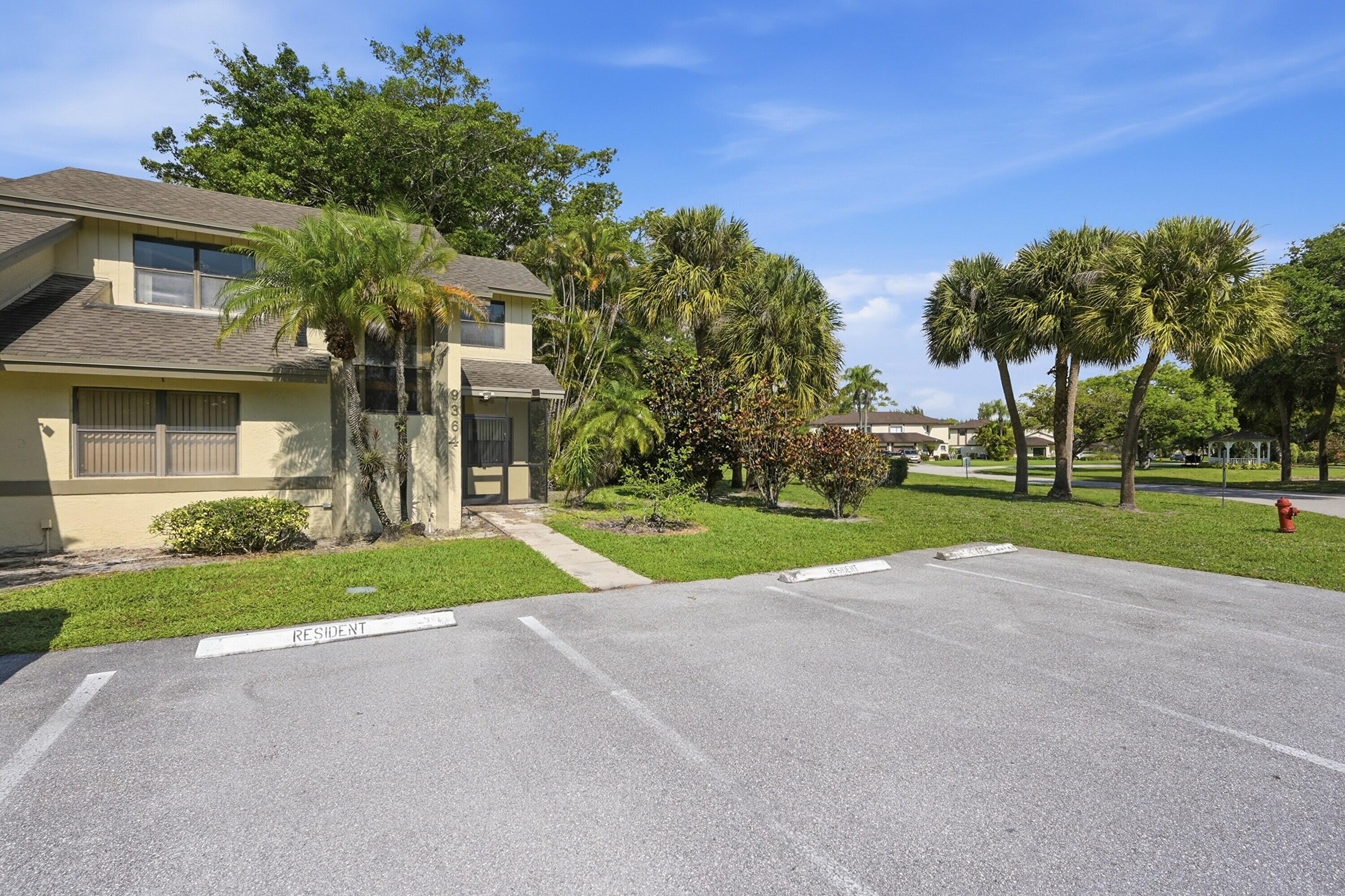 9364 Ketay Circle, Unit 5 Boca Raton, FL 33428 - Photo 1 of 42 a view of a house with a big yard and palm trees