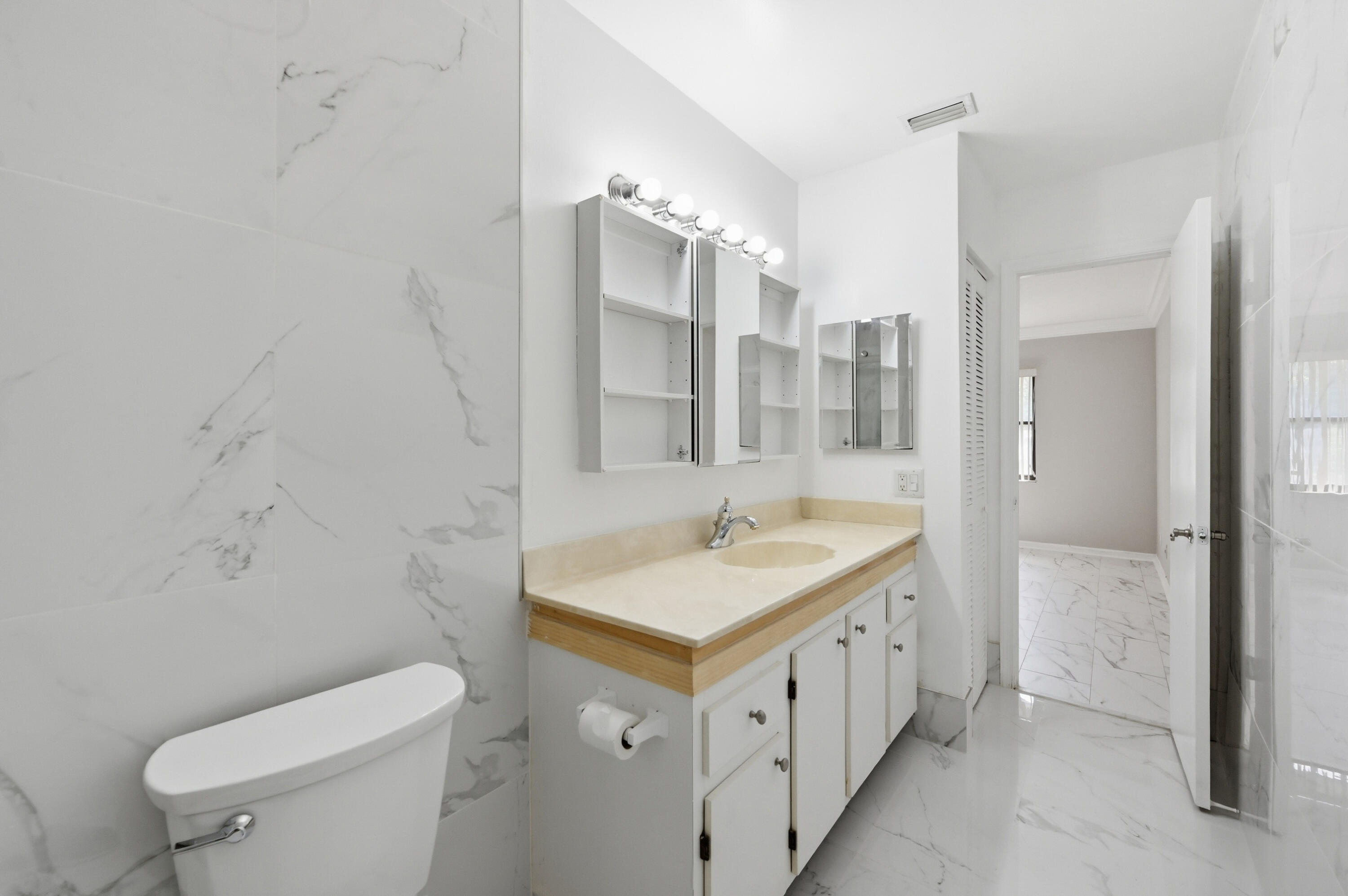 9364 Ketay Circle, Unit 5 Boca Raton, FL 33428 - Photo 17 of 42 a bathroom with a double vanity sink toilet and shower