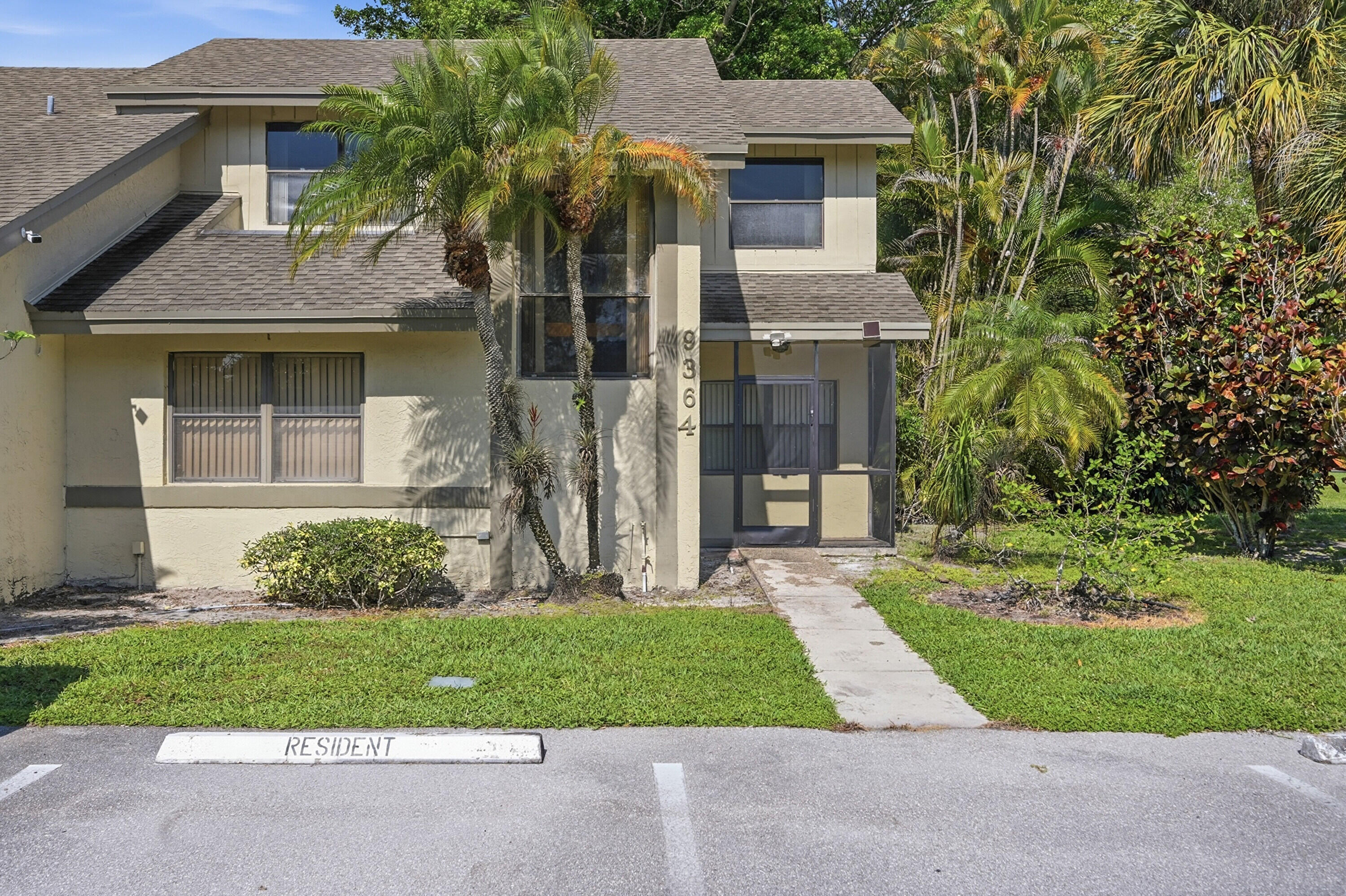 9364 Ketay Circle, Unit 5 Boca Raton, FL 33428 - Photo 2 of 42 front view of a house with a yard