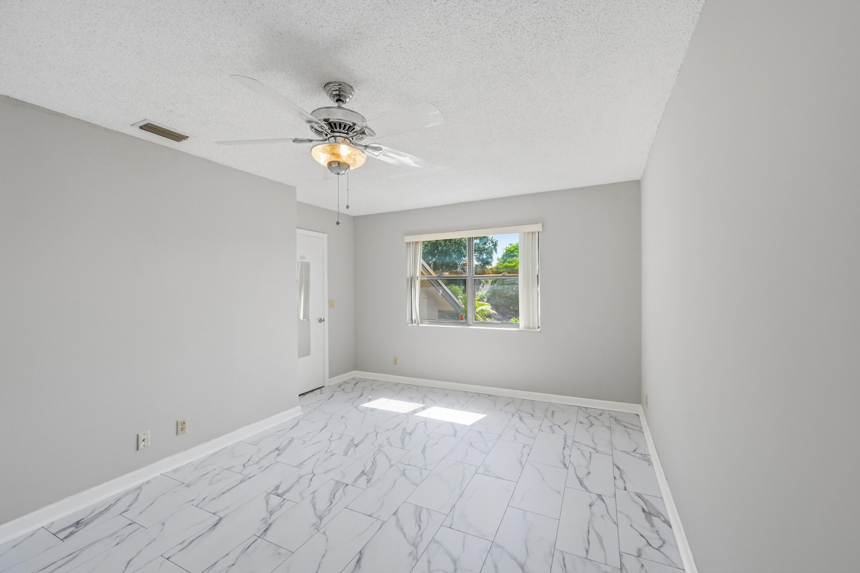 9364 Ketay Circle, Unit 5 Boca Raton, FL 33428 - Photo 21 of 42 wooden floor in an empty room with a window