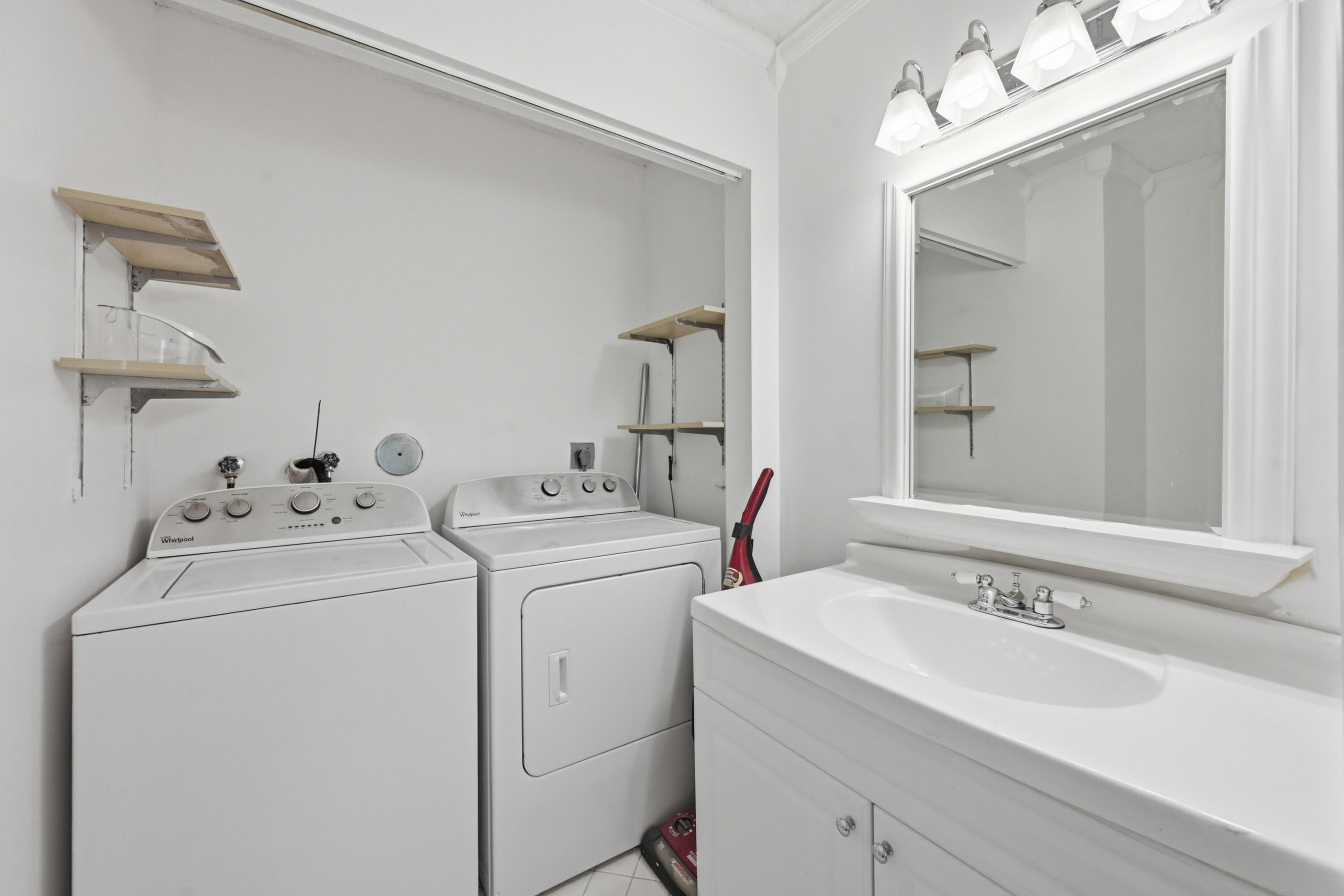 9364 Ketay Circle, Unit 5 Boca Raton, FL 33428 - Photo 27 of 42 a view of bathroom with a sink and washer dryer