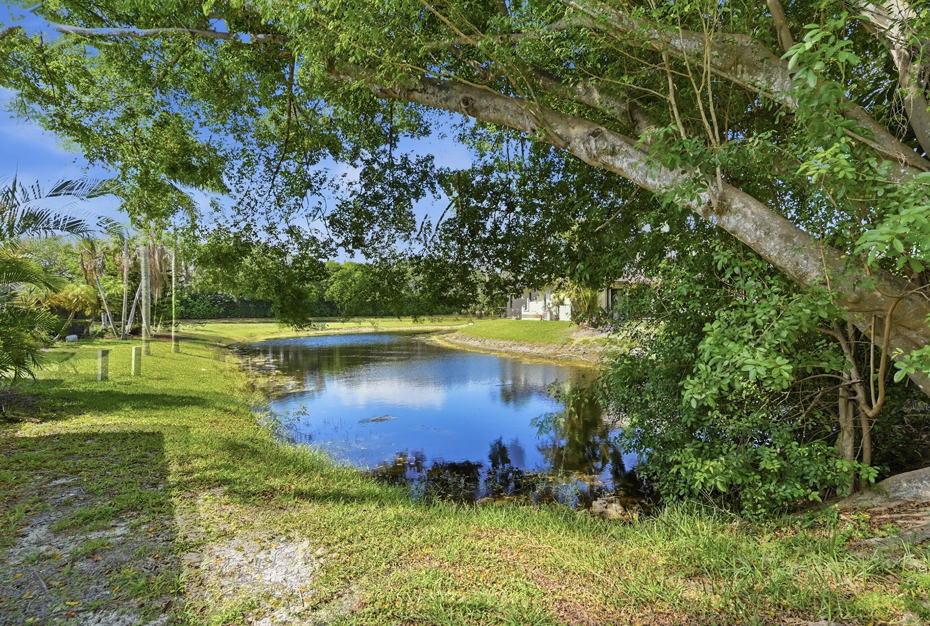 9364 Ketay Circle, Unit 5 Boca Raton, FL 33428 - Photo 33 of 42 a view of a lake with a yard