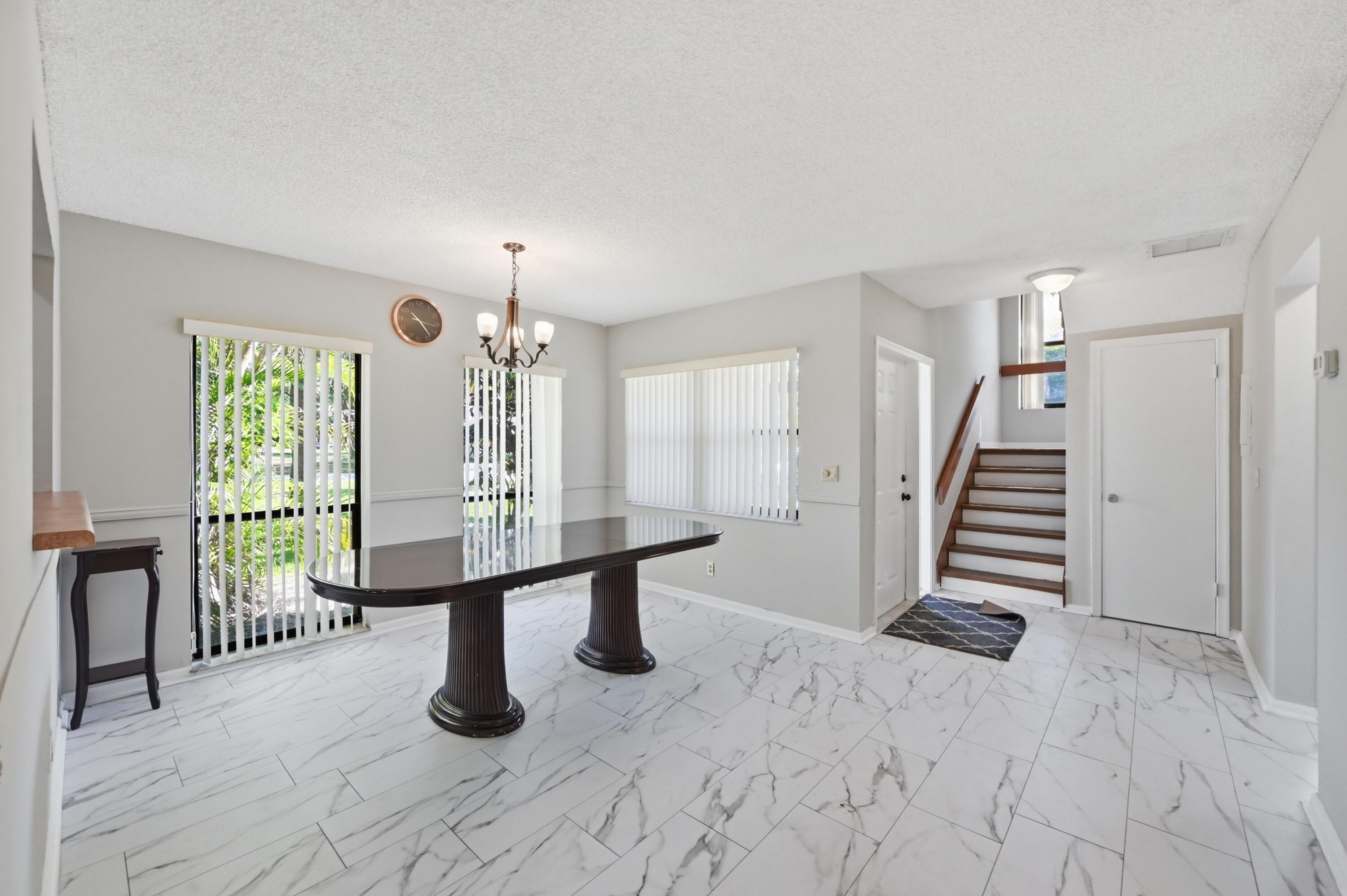 9364 Ketay Circle, Unit 5 Boca Raton, FL 33428 - Photo 6 of 42 an empty room with windows and stairs