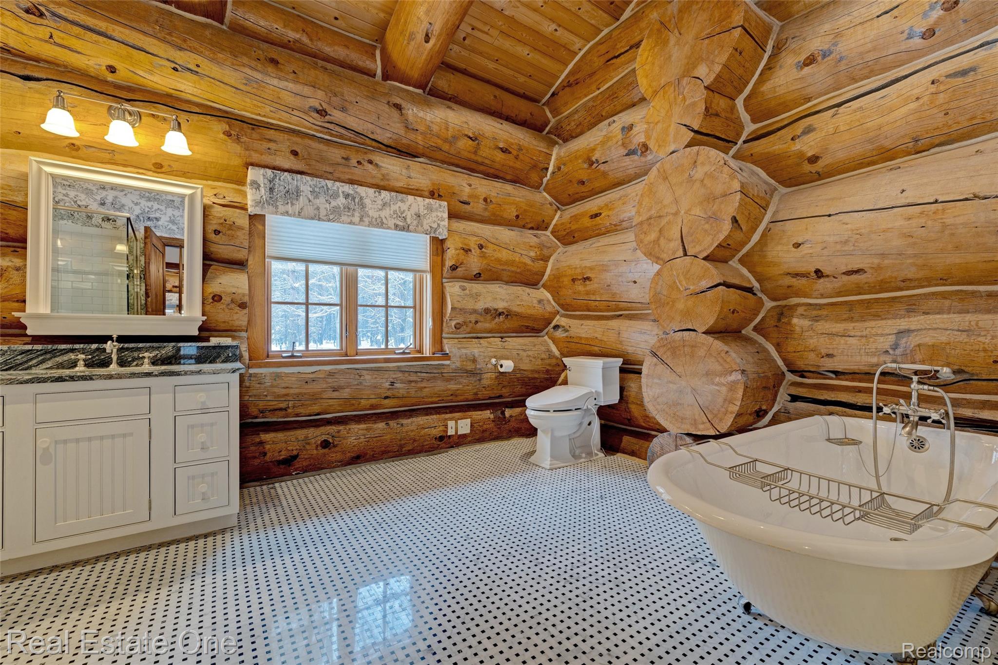 4340 Lahring Road Holly, MI 48442 - Photo 21 of 89 Full bath with a freestanding tub, vanity, a wooden ceiling with exposed beams, and rustic walls