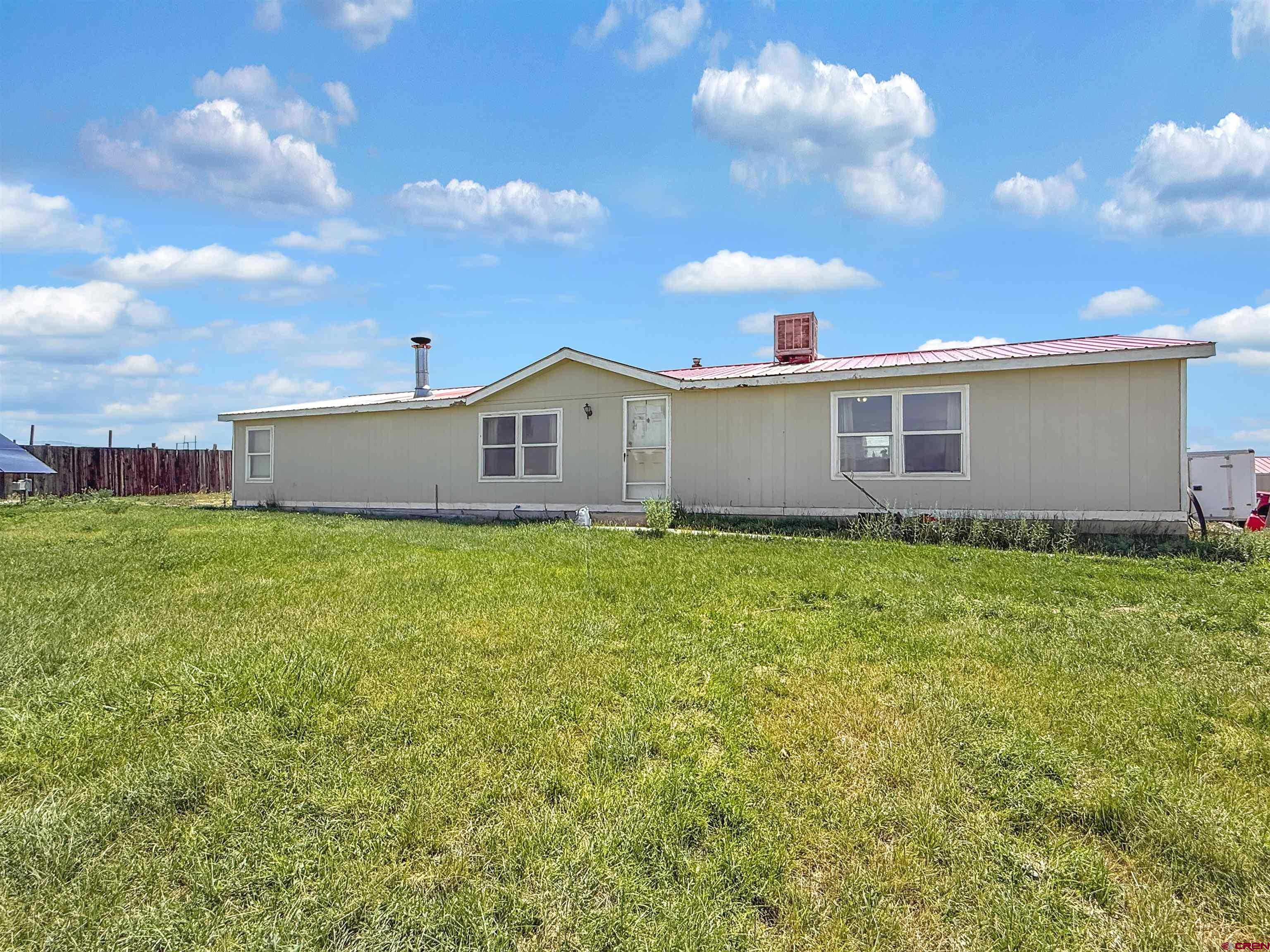 a view of a house with a backyard