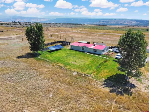 a view of workspace with wooden floor and furniture